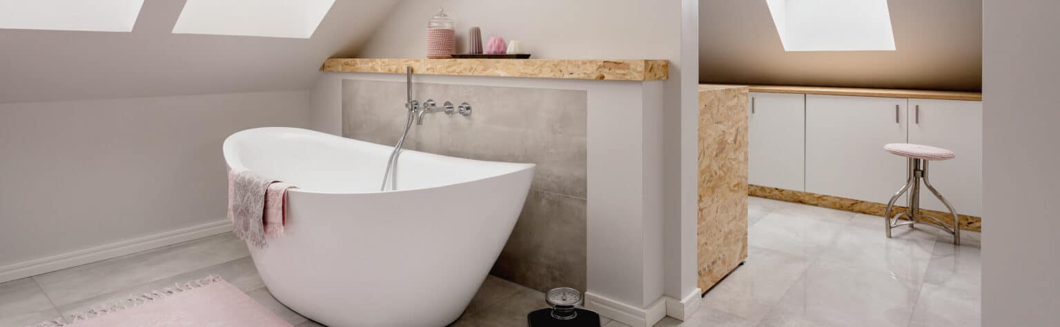 Bathroom in the attic with an oval bathtub